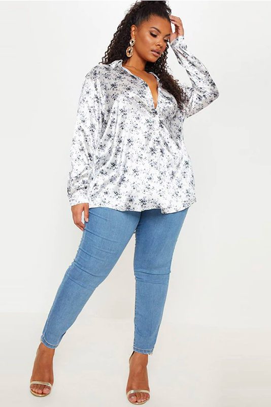 Model Wearing A White Plus Size Button Down Shirt, With A Floral Image Design